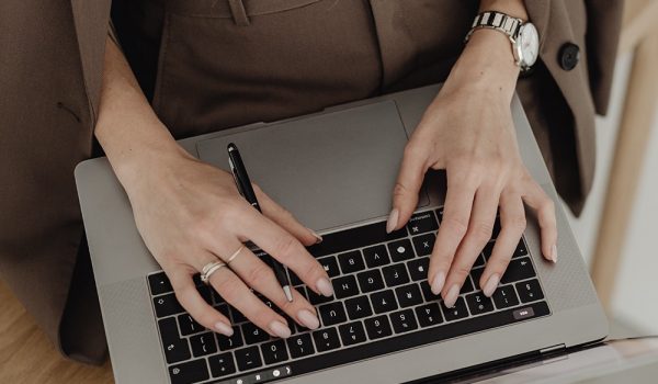kaboompics_young-entrepreneur-dressed-in-brown-suit-holds-laptop-27938_1